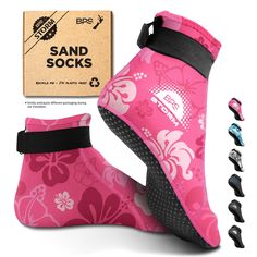 pink booties with black soles and flower design on them, next to box