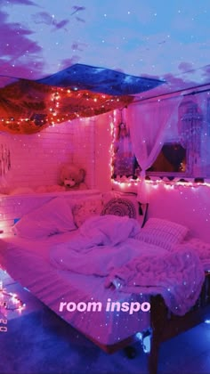 a bedroom with pink lights on the ceiling, and a bed in the middle of it