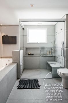 a bathroom with a tub, toilet and sink