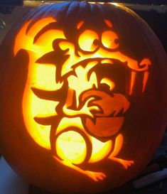 a carved pumpkin with an image of a dog on it's face in the center