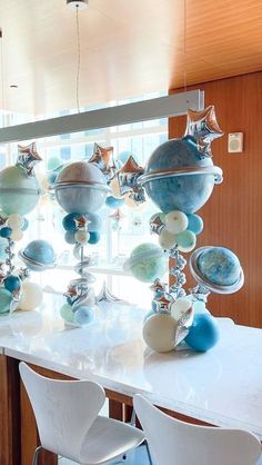 a white table topped with lots of blue and white ornaments