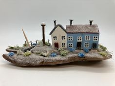 a small blue house sitting on top of a rock