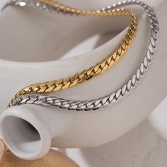 Elevate your style with this stunning Statement Snake Chain Choker Necklace. Crafted from high-quality 316L stainless steel and featuring a sleek metal texture, this collar is a timeless piece that adds a touch of elegance to any outfit. The necklace is beautifully plated with 18K gold using advanced PVD technology, ensuring a durable and luxurious finish. - Product Details: - Material: 316L Stainless Steel - Plating: 18K Real PVD Gold Plated - Color Options: Gold, Silver - Chain Length: 410 mm Essential Outfits, 15 Necklace, Gold Snake Chain, Gold Chain Choker, Cuban Link Chain Necklaces, Snake Necklace, Gold Choker Necklace, Metal Texture, Waterproof Jewelry