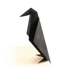 an origami bird is shown on a white surface