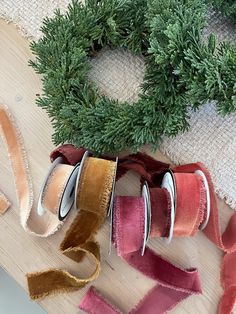 some ribbons are laying on a table next to a wreath