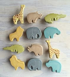 the cookies are shaped like animals and have giraffes, elephants, and alligators on them