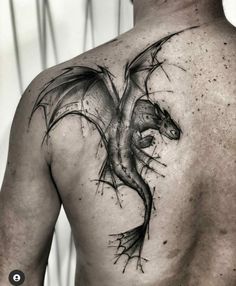 a man with a dragon tattoo on his back is looking down at the viewer's chest