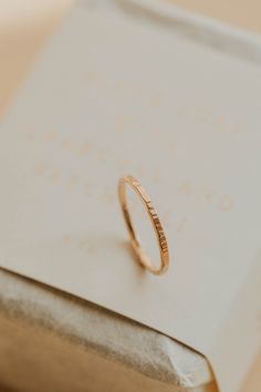 The stacking band of your hand-made-ring dreams! The same hammering technique used on our Marlo Hoops is used to create the Marlo Band! Perfectly textured for that hand forged look we all love so much. Band is 1.5mm wide and is lightly hammered. Available in 14kt Gold Fill + Sterling Silver. Handmade in Eau Claire, WI. Our jewelry is handmade so each piece will be unique and may vary slightly from what is pictured. Hammered Stackable Round Band Rings As Gifts, Adjustable Hammered Stackable Wedding Rings, Simple Hammered Stackable Rings For Gifts, Simple Hammered Stackable Rings As Gift, Simple Hammered Stackable Rings For Gift, Minimalist Hammered Engraved Promise Ring, Simple Hammered Stackable Rings Gift, Hammered Yellow Gold Rings For Everyday, Minimalist Engraved Hammered Wedding Ring