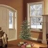 a living room filled with furniture and a christmas tree