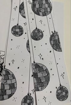 some black and white paper with ornaments hanging from it