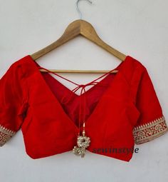 1. Fabric - Silk. 2. V NECK BLOUSE.  3. Elbow Sleeves Blouse. Red V-neck Blouse For Wedding, V-neck Blouse Piece For Wedding Festivals, Traditional V-neck Wedding Blouse, Embroidered V-neck Wedding Blouse, V-neck Blouse With Zari Work For Wedding, Padded Saree Blouse For Wedding, Wedding V-neck Blouse With Zari Work, Formal Saree Blouse For Navratri, Elegant Blouse For Wedding And Navratri