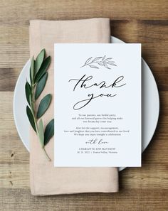 the wedding menu is displayed on a plate with an olive branch and greenery around it