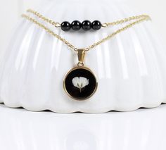 "*Baby's breath flower on black background *Gold stainless steel double layer necklace: length 19\"  *Black tourmaline gemstone bead *Pendant diameter: 0.8\" This floral boho necklace is the perfect accessory for nature lovers ! It makes a thoughtful and dainty present for any occasion, with its beautiful natural Tourmaline gemstones.  It's a great gift option for a birthday, Christmas 🎄, or as a little treat for yourself! 😊 -- ✨CUSTOM ORDER: We're happy to create custom orders to suit your unique style and preferences. Need a different length or color for your jewelry? Just send us a message with your request and we'll work with you to make it happen!  🌼INFORMATIONS:  *Gift wrapping option available. *Handmade with care in Dordogne, France ✍️Where to find us? *Instagram: www.instagram. Flower On Black Background, Gold Boho Necklace, Background Gold, Double Layer Necklace, Layer Necklace, Dainty Gold Necklace, Bead Pendant, Baby's Breath, Floral Necklace