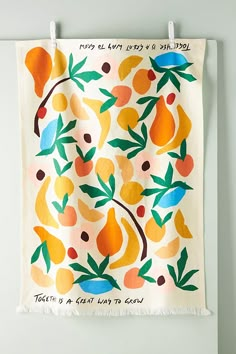 a tea towel hanging on a wall with fruit and leaves printed on it, which reads, today is a great day to go