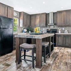 a kitchen with wooden floors and black appliances