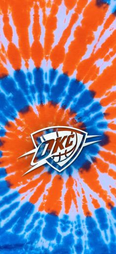 an orange and blue tie - dye shirt with the letter kfc on it's center