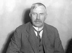 an old black and white photo of a man in a suit with a moustache