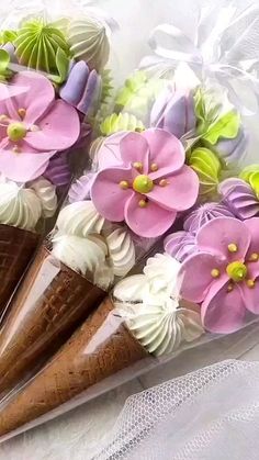 some ice cream cones are decorated with flowers