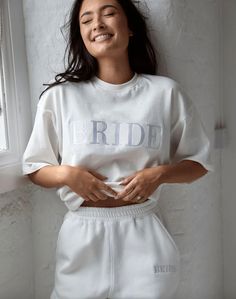 Designed with every bride-moment in mind. This tee is essential to your hen/bach party style. Make a serious statement and stand out for all the right reasons.  From daytime errands to partying with your girls, it's so versatile, you can wear with anything, anywhere. 100% premium cotton, 100% good times guaranteed. Shop the matching sweatpants here: https://www.etsy.com/uk/listing/1295734299 Shop the matching quarter zip sweat here: https://www.etsy.com/uk/listing/1295720591 PRODUCT DETAILS:  - Bride Embroidery Designs, Relaxed Fit Embroidered Tops For Loungewear, White Crew Neck Top With Embroidered Text, Champagne Embroidery, Bride Sweats, Bachelorette Tees, Bride Tee, Bachelorette Outfits, White Bride