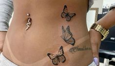 a woman's stomach with butterflies on it and the word love written in cursive writing