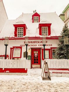 a red and white building covered in snow