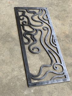 a metal grate sitting on top of a cement floor