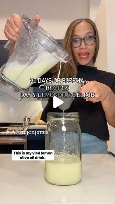 a woman pouring milk into a glass jar on top of a kitchen counter with the words 30 days of fezema day 4 lemon eliicive eliif