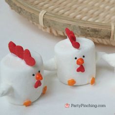 three marshmallows shaped like chickens in front of a basket with text reading chinese new year rooster marshmallows