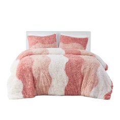 a bed covered in pink and white fur