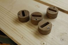 four wooden objects sitting on top of a table