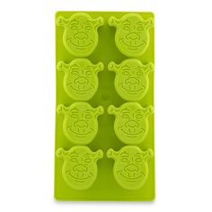 an ice tray with five green bears on it