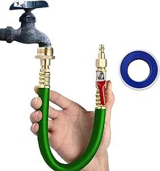 a hand holding a hose connected to a faucet