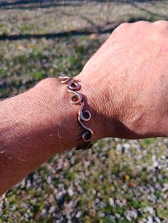 a man's hand with a bracelet on it