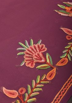 This beautiful georgette saree comes in an eye-catching shade of Plum and it drapes like a dream. This saree features the magnificent aari work of Kashmir on its border and pallu. The spellbinding floral embroidery inspired by the scenery in the valley, along with the beautiful color combinations makes this saree an exquisite drape This saree comes with an unstitched blouse fabric with aari work on the sleeves. It is ready to wear with falls and pico included. Bring a bit of Kashmir to your home with this graceful saree!Note: Minor color differences are possible due to variation in screen settings and other factors.Note: Minor inconsistencies such as stencil marks, asymmetry in the embroidery can be expected, and being characteristic these are not considered as defects. Georgette Saree, Beautiful Color Combinations, Georgette Sarees, Blouse Fabric, The Valley, Floral Embroidery, A Dream, Color Combinations