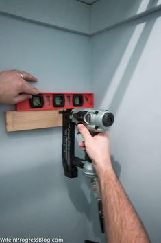 a man is using a drill bit to fix a hole in the wall