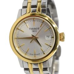 Tissot analog watch in two-toned silver and gold stainless steel with a link band. Features a round face with a white sapphire crystal inner face, gold dial and hands, and a butterfly clasp closure. Includes additional links. Brand = Tissot Condition = 8/10, Very good, hairline scratches to hardware Thickness = 17mm Face Diameter = 28mm Wrist Size = 17cm Hardware = Stainless Steel SKU = 22671-68 Two Tone Watch, Analog Watch, Round Face, Scarf Jewelry, Sneaker Collection, White Sapphire, Sapphire Crystal, A Butterfly, Silver Watch