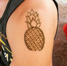 a woman with a tattoo on her arm has a small pineapple drawn on it