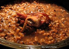 a glass bowl filled with beans and meat