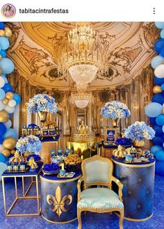 a blue and gold themed party with balloons, tables, chairs and decorations on the wall