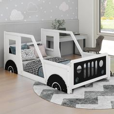 a child's bedroom with a bed and desk in the shape of a truck