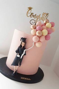 a cake with a barbie doll on top and balloons in the shape of a balloon