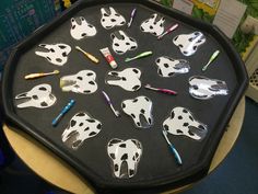 the tray has many different animal shaped objects on it, including toothbrushes and markers