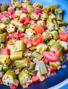 a blue bowl filled with chopped up vegetables