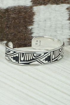 This sterling silver and bracelet was made by Navajo silversmith Kerry Begay. The inside is signed KB and stamped sterling.Size: 5" (will fit up to a 6" wrist)Gap: 1"Width: 1/2"Free shipping on all orders! We ship with USPS and always include tracking. All orders ship within a day of payment.Returns are accepted up to 30 days after you receive your order. Just send us a message. Our shop offers cash back or store credit. The item must be returned in new condition. Sterling Silver Bracelets Bangles Native American, Sterling Silver Bracelet, Native American Jewelry, Free Jewelry, Sterling Silver Bracelets, Cuff Bracelets, Silver Bracelet, Gap, Stamp