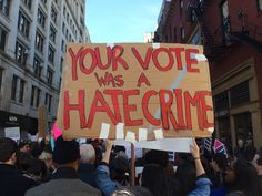 a group of people holding signs in the street