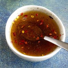 a spoon in a bowl filled with liquid