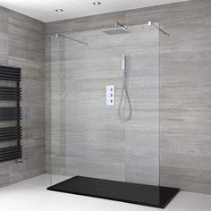 a bathroom with a glass shower door and towel rack on the wall next to it