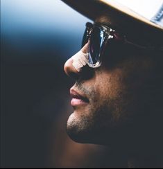 a close up of a person wearing sunglasses and a hat