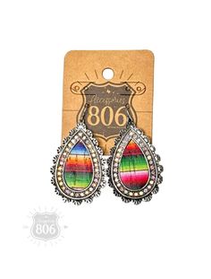 This earring features a western style silver teardrop filled with a serape design and outlined in AB rhinestones. It hangs from a french hook and is approximately 2.25 inches in length. Matching necklace available also. Details • Made in United States • Weight: 0.68 oz (19.28 g) G Names, Another Love, Some Text, Athleisure Wear, Matching Necklaces, Western Style, Teardrop Earrings, Western Fashion, United States