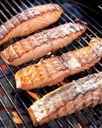 three pieces of meat cooking on a grill